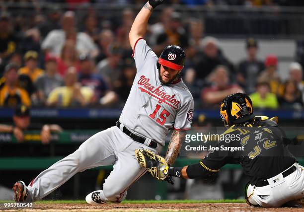 Matt Adams of the Washington Nationals is tagged out by Elias Diaz of the Pittsburgh Pirates at the plate during the seventh inning at PNC Park on...