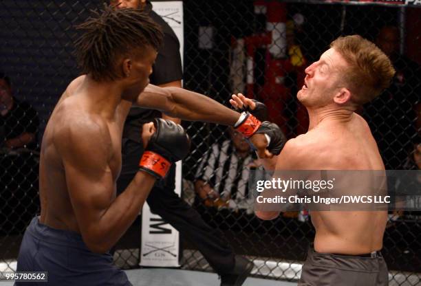 Jalin Turner punches Max Mustaki in their lightweight bout during Dana White's Tuesday Night Contender Series at the TUF Gym on July 10, 2018 in Las...