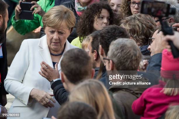 German Chancellor Angela Merkel mingles in the crowd during the central celebration of the German Unity Day in Mainz, Germany, 03 October 2017. The...