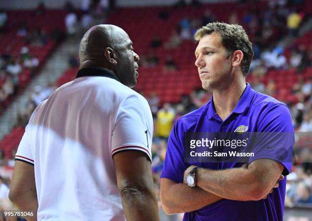 Head coach Luke Walton of the Los Angeles Lakers talks with Los Angeles Lakers president of basketball operations Earvin 'Magic' Johnson during the...