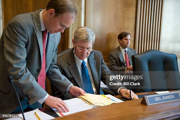 Sen.Tim Johnson, D-S. Dak., speaks with an aide as he prepares to chair the Senate Energy and Natural Resources Committee's Water and Power...