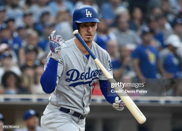 Cody Bellinger of the Los Angeles Dodgers flips his bat after flying out during the second inning of a baseball game against the San Diego Padres at...