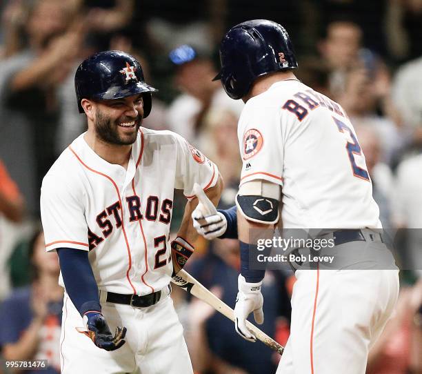 Alex Bregman of the Houston Astros celebrates with Jose Altuve after hitting a home run in the seventh inning against the Oakland Athletics at Minute...