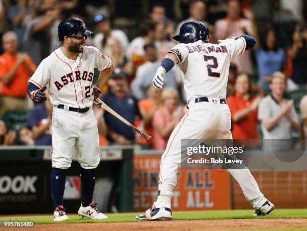 Alex Bregman of the Houston Astros celebrates with Jose Altuve after hitting a home run in the seventh inning against the Oakland Athletics at Minute...