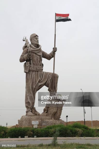 Photo taken in Kirkuk, Iraq, on May 7 shows a statue of a Kurdish soldier holding the Iraqi flag. ==Kyodo