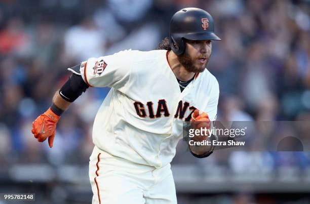 Brandon Crawford of the San Francisco Giants runs to first base for a single against the Chicago Cubs in the second inning at AT&T Park on July 10,...