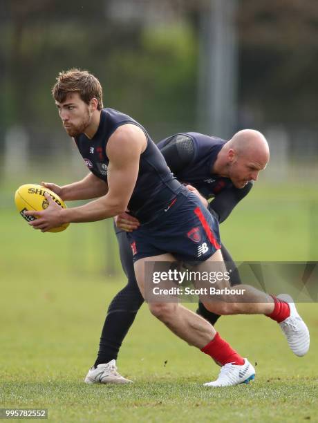 Jack Viney of the Demons is tackled by Nathan Jones of the Demons during a Melbourne Demons AFL training session at Gosch's Paddock on July 11, 2018...