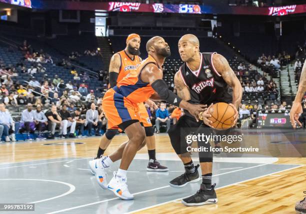 Baron Davis co-captain of 3's Company tries a steal from Dahntay Jones of Trilogy during game 1 in week three of the BIG3 3-on-3 basketball league on...