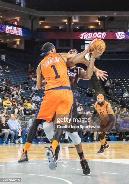 Al Harrington co-captain of Trilogy gets fouled by Demarr Johnson captain of 3's Company during game 1 in week three of the BIG3 3-on-3 basketball...