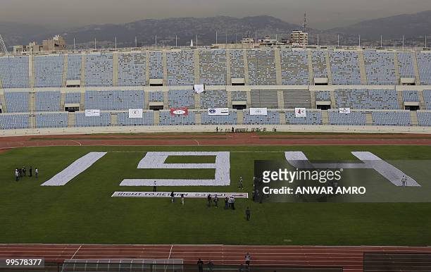 The world's largest keffiyeh, the traditional black-and-white chequerred Arab headdress, is laid on the grounds of Beirut's Sport City Stadium on May...