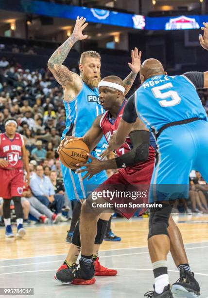 Bonzi Wells of Tri-State weaves between Chris 'Birdman' Andersen of Power and Cuttino Mobley co-captain of Power during game 3 in week three of the...