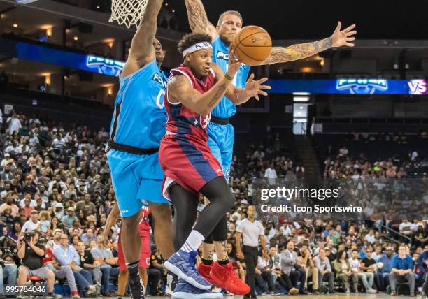 David Hawkins of Tri-State takes a pass option as Chris 'Birdman' Andersen of Power and Glen 'Big Baby' Davis co-captain of Power guard the net...