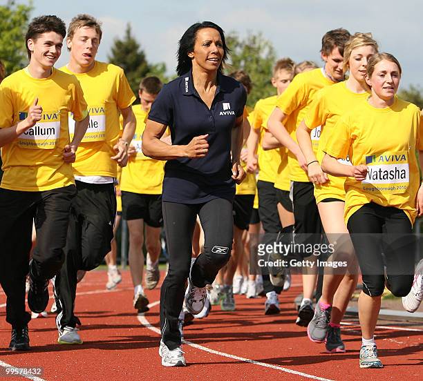 Kelly Holmes takes a warm up lap around the track with the athletes during the Aviva sponsored mentoring day for young athletes at Loughborough...