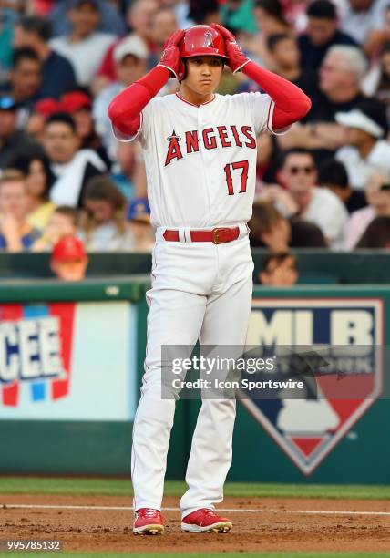 Los Angeles Angels of Anaheim designated hitter Shohei Ohtani leads off first base after drawing a walk in the first inning of a game against the...