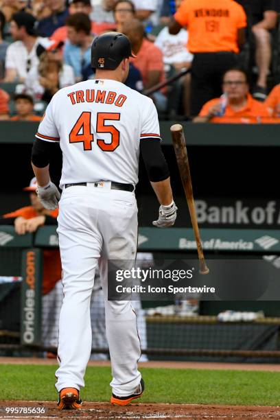Baltimore Orioles designated hitter Mark Trumbo tosses his bat after striking out to end the first inning during the game between the New York...