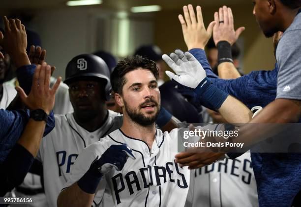 Austin Hedges of the San Diego Padres is congratulated after hitting a three-run home run during the fifth inning of a baseball game against the Los...