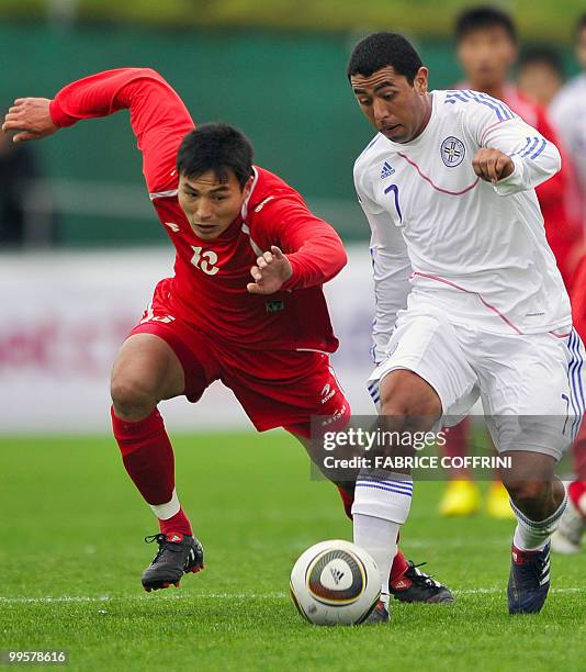 Paraguay's Jorge Achucarro competes for the ball with North Korea's Pak Chol Jin during a friendly football game in Nyon on May 15, 2010 ahead of...