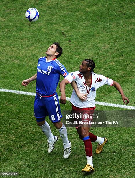 Frank Lampard of Chelsea is challenged by Frederic Piquionne of Portsmouth during during the FA Cup sponsored by E.ON Final match between Chelsea and...