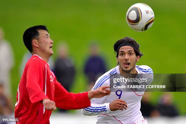 Paraguay's Roque Santa Cruz vies for the ball with North Korea's Ri Jun II during a friendly football game, in Nyon on May 15, 2010 ahead of their...