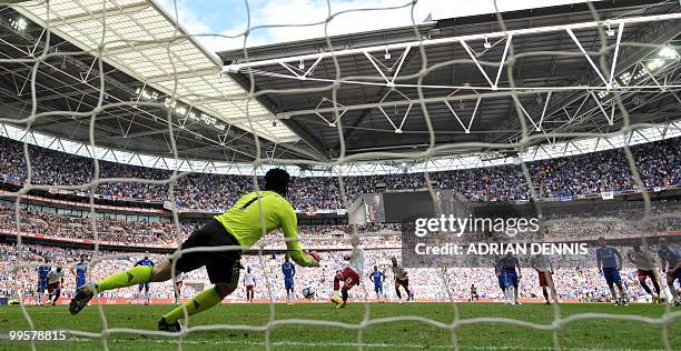 Chelsea goalkeeper Petr Cech saves a penalty from Portsmouth's Kevin-Prince Boateng during the FA Cup Final football match at Wembley, in north...