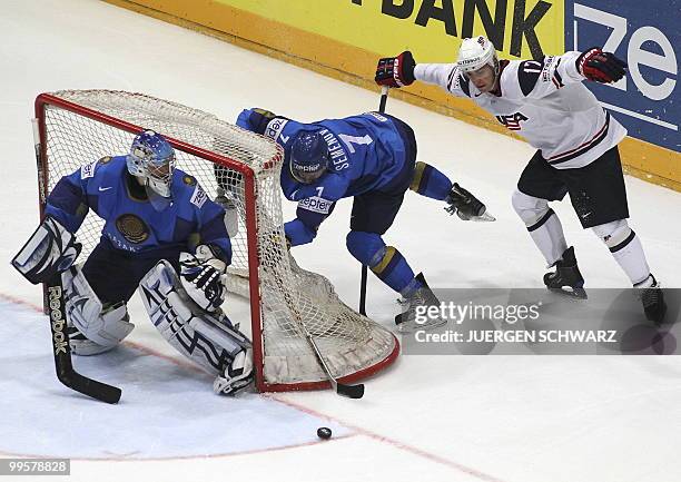 S Brandon Dubinsky vies with Kazakhstan's Maxim Semenov and goalkeeper Alexei Kuznetsov during the IIHF Ice Hockey World Championship match USA vs...