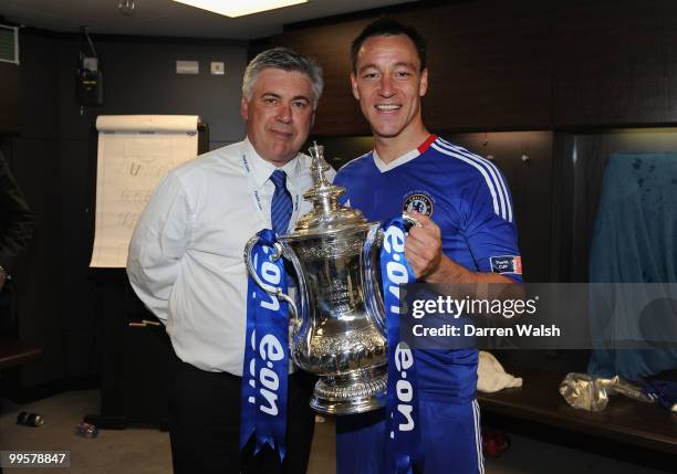 Chelsea Manager Carlo Ancelotti and John Terry of Chelsea pose with the trophy in the dressing room at the end of the FA Cup sponsored by E.ON Final...