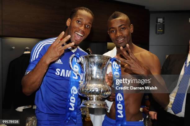 Didier Drogba and Salomon Kalou of Chelsea pose with the trophy in the dressing room at the end of the FA Cup sponsored by E.ON Final match between...