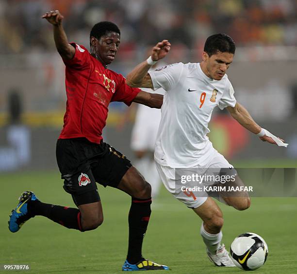 Umm Salal's Brazilian player Magno Alves competes with Al-Rayyan's Daniel Gouma during their Qatari Emir Cup final football match in Doha on May 15,...