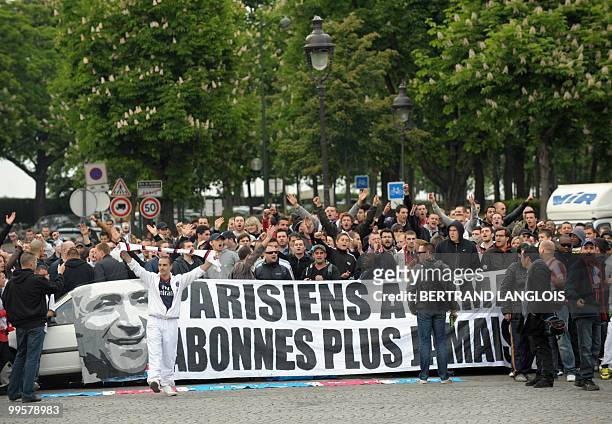 People hold a banner featuring former French president of Paris Saint-Germain football club , Francis Borelli during a "pacific" demonstration of the...
