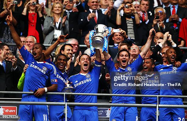 John Terry and Frank Lampard lift the trophy as their team-mates celebrate following victory in the FA Cup sponsored by E.ON Final match between...