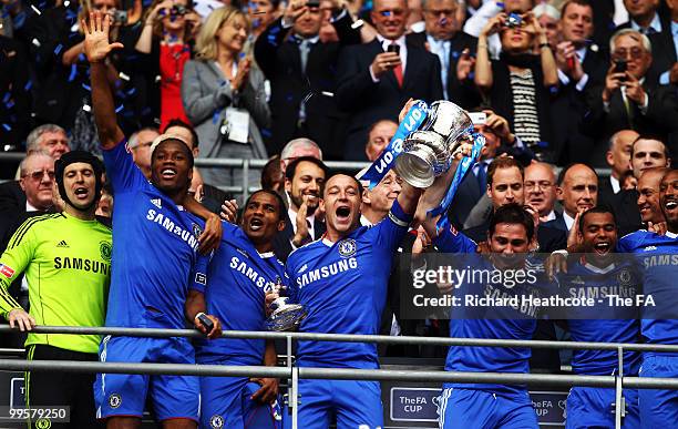 John Terry and Frank Lampard lift the trophy as their team-mates celebrate following victory in the FA Cup sponsored by E.ON Final match between...