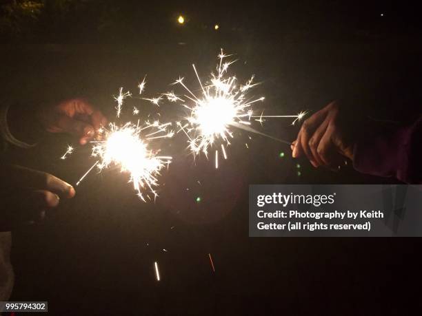 youngsters playing with sparklers to celebrate july 4th usa independence day holiday - fort greene stock pictures, royalty-free photos & images