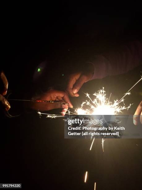 youngsters playing with sparklers to celebrate july 4th usa independence day holiday - fort greene stock pictures, royalty-free photos & images