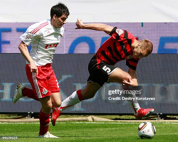 Branko Ilic of FC Lokomotiv Moscow battles for the ball with Vitali Grishin of FC Amkar Perm during the Russian Football League Championship match...