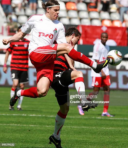 Tomislav Dujmovic of FC Lokomotiv Moscow battles for the ball with Aleksei Pomerko of FC Amkar Perm during the Russian Football League Championship...