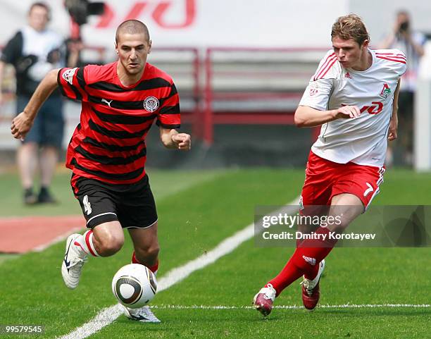 Dmitri Tarasov of FC Lokomotiv Moscow battles for the ball with Vitaliy Fedoriv of FC Amkar Perm during the Russian Football League Championship...