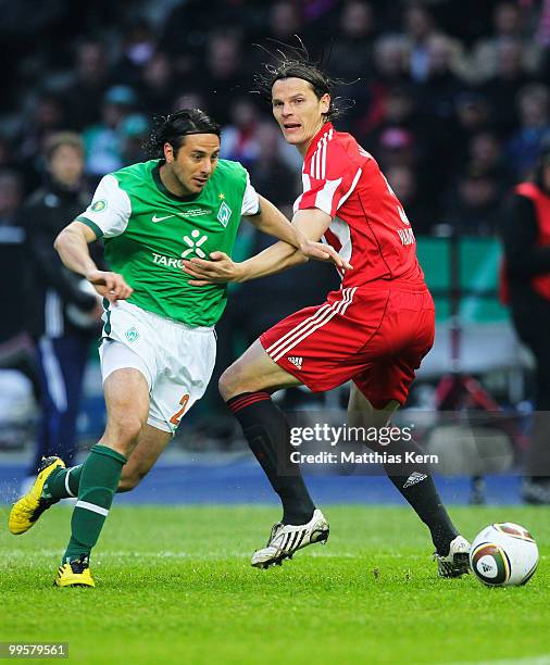 Claudio Pizarro of Bremen and Daniel van Buyten of Bayern battle for the ball during the DFB Cup final match between SV Werder Bremen and FC Bayern...