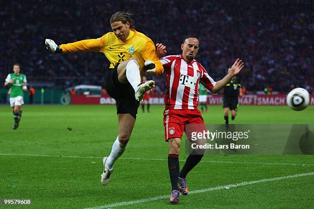 Goalkeeper Tim Wiese of Bremen and Franck Ribery of Bayern battle for the ball during the DFB Cup final match between SV Werder Bremen and FC Bayern...
