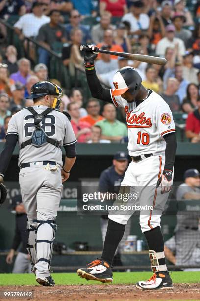 Baltimore Orioles center fielder Adam Jones slams his bat after striking out with the bases loaded to end the fifth inning during the game between...