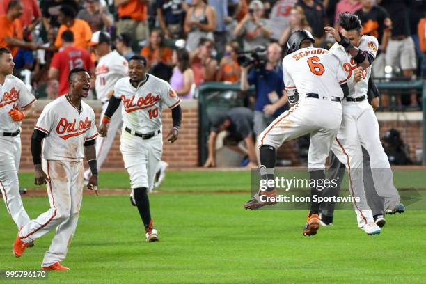 Baltimore Orioles second baseman Jonathan Schoop jumps in the air with shortstop Manny Machado after hitting a game winning single in the ninth...