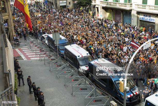 Catalan pro-independence activists gather outside National Police Headquarters during a mass demonstration during a strike in Barcelona, Spain, 03...