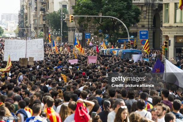 Catalan pro-independence activists take part in a mass demonstration during a strike in Barcelona, Spain, 03 October 2017. Labor unions and...