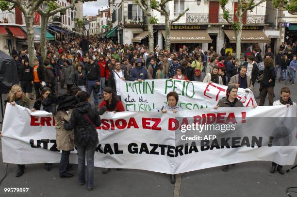 People hold a banner during a demonstration to protest against the repression affecting young Basque activists, on May 15, 2010 in Saint-Jean-de-Luz...