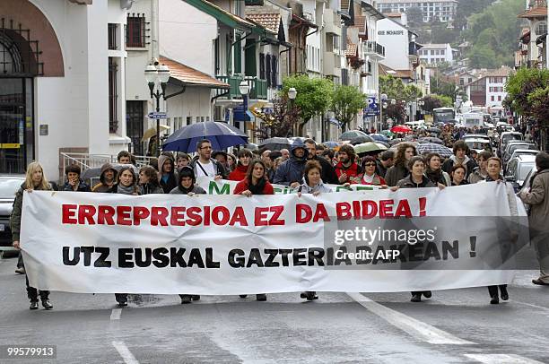 People hold a banner during a demonstration to protest against the repression affecting young Basque activists, on May 15, 2010 in Saint-Jean-de-Luz...