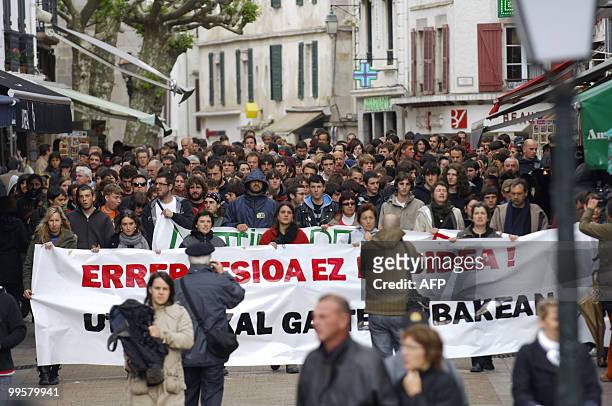 People hold a banner during a demonstration to protest against the repression affecting young Basque activists, on May 15, 2010 in Saint-Jean-de-Luz...