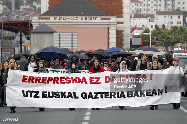 People hold a banner during a demonstration to protest against the repression affecting young Basque activists, on May 15, 2010 in Saint-Jean-de-Luz...