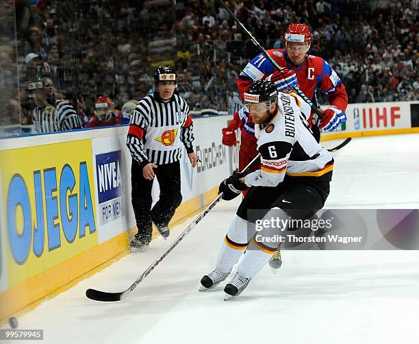 Sven Butenschoen of Germany battles for the puck with Ilya Kovalchuk of Russia during the IIHF World Championship qualification round match between...