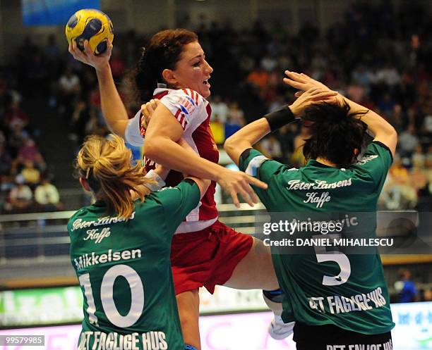 Mikkelsen Henriette and Acimovic Gorica of Viborg vies for the ball with Neagu Cristina of Oltchim Ramnicu Valcea during a second leg women handball...