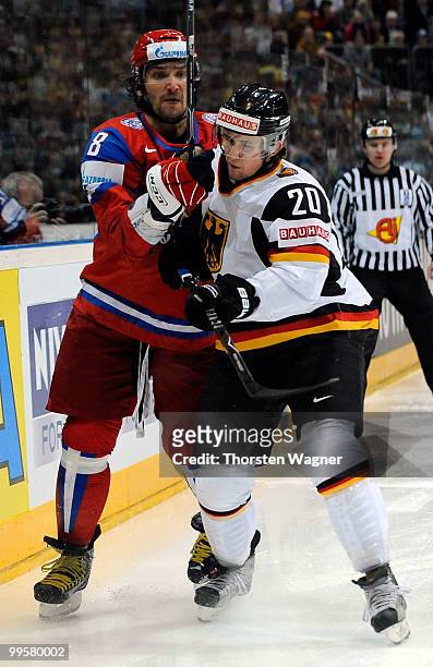 Robert Dietrich of Germany battles for the puck with Alexander Ovechkin of Russia during the IIHF World Championship qualification round match...