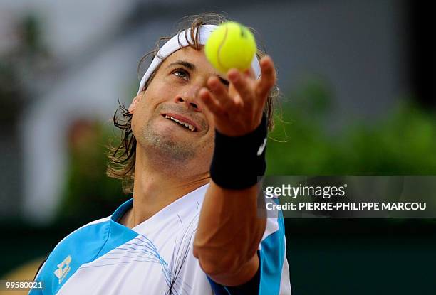 Spain's David Ferrer serves to Swiss Roger Federer during their semi-final match of the Madrid Masters on May 15, 2010 at the Caja Magic sports...